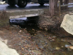 Before:  The gravel buildup under the SR 2051 culvert bridge was a constant maintenance effort for PennDOT. (Looking downstream.)